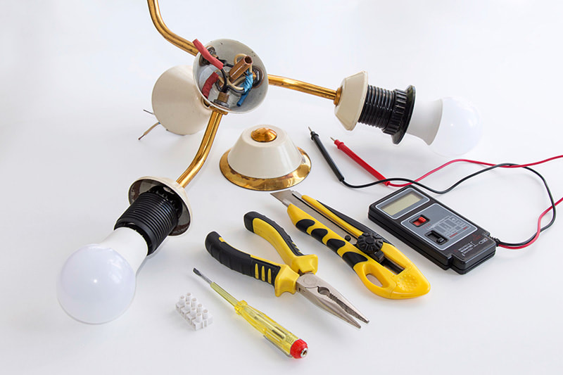 Light fitting and electrical tools ready to be installed by an electrician