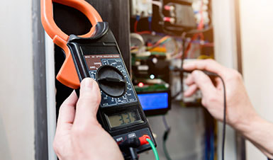 One of our electricians detecting an electrical fault using a voltmeter reading device